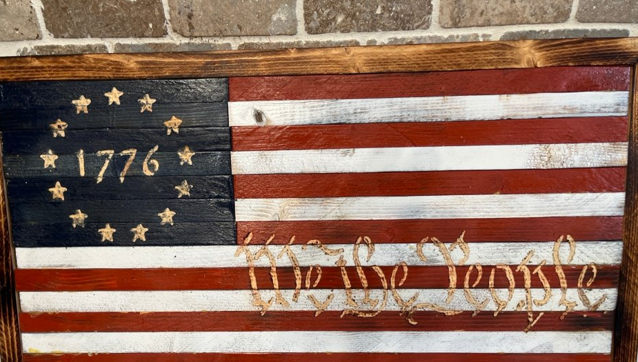 We the People flag with 1776 canton and carved script text
